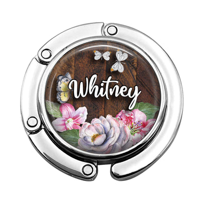 a round mirror with a picture of flowers on it
